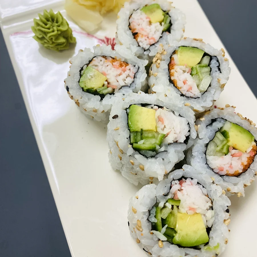 California roll pieces with imitation crab, avocado and cucumber on a white plate with ginger and wasabi at Hana Sushi, Winnipeg