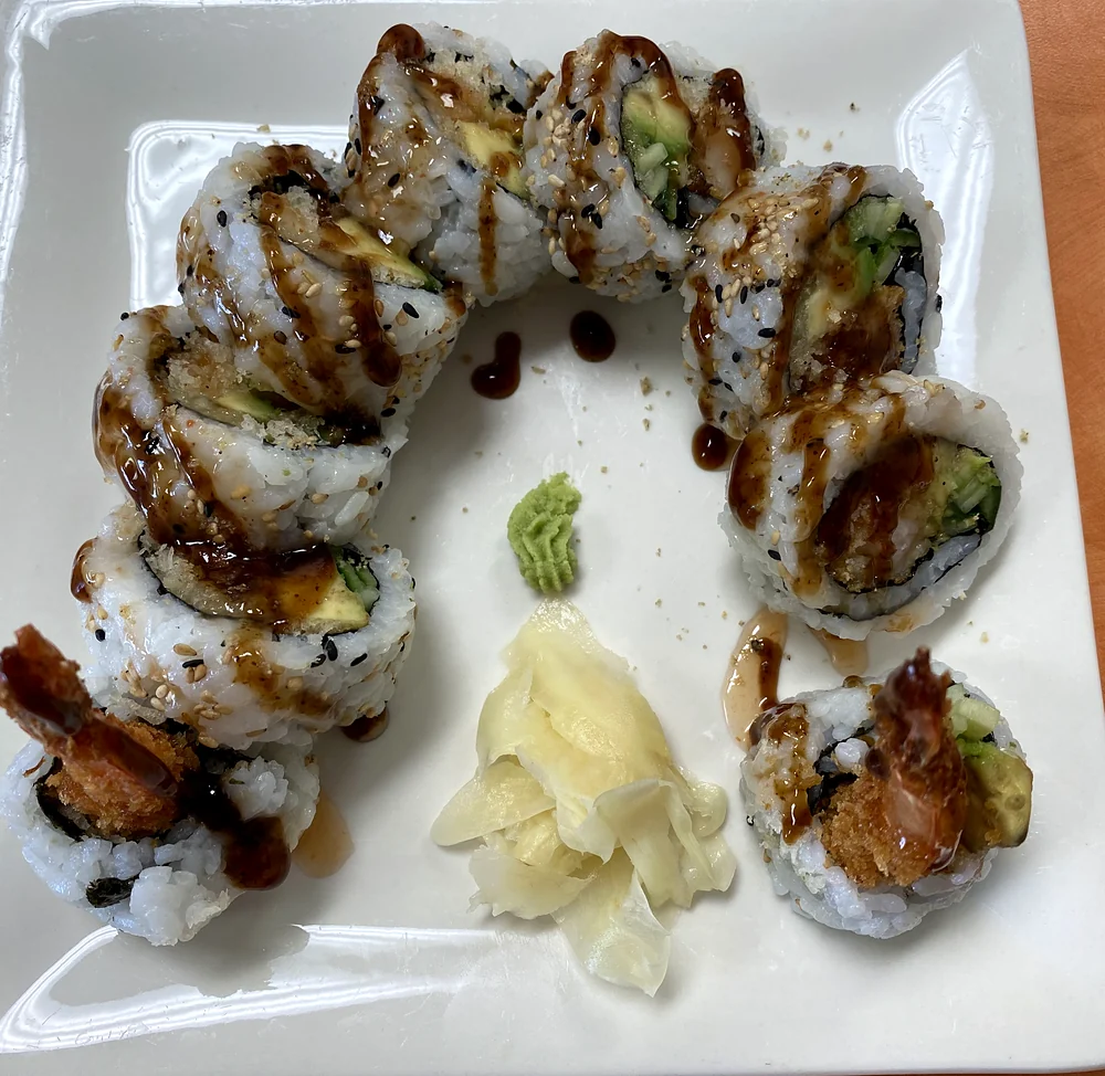 Dynamite roll with tempura shrimp, avocado and cucumber, topped with sweet sauce, with ginger and wasabi at Hana Sushi, Winnipeg