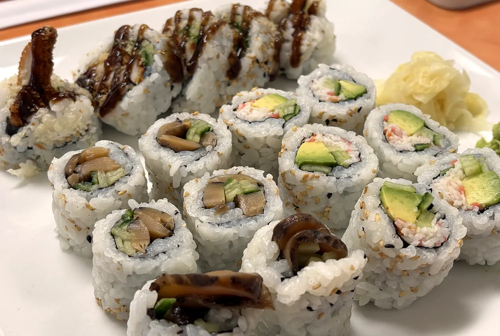 Platter of sushi rolls: chicken teriyaki roll, California roll and mushroom rolls with pickled ginger at Hana Sushi, Winnipeg